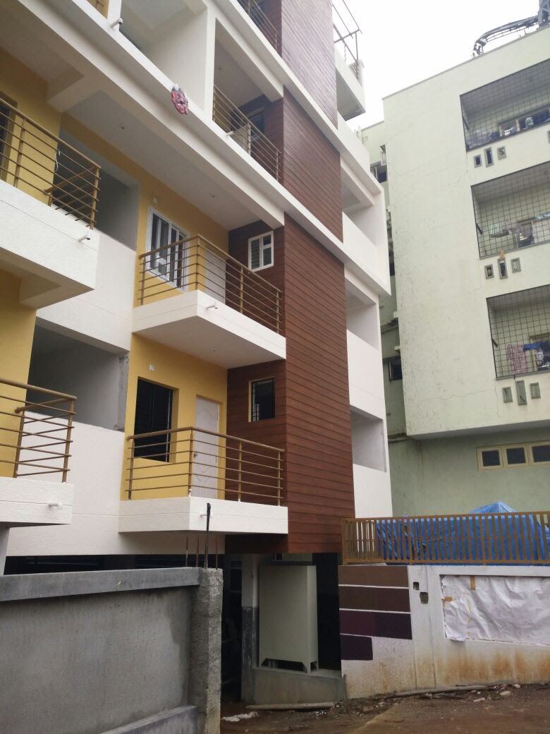 The wood-finish wall and yellow balconies seen from the side