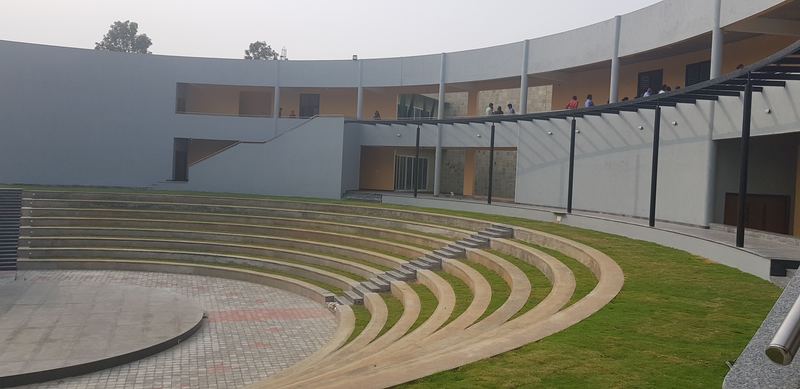 Stepped amphitheatre seating with grass terraces and a paved stage
