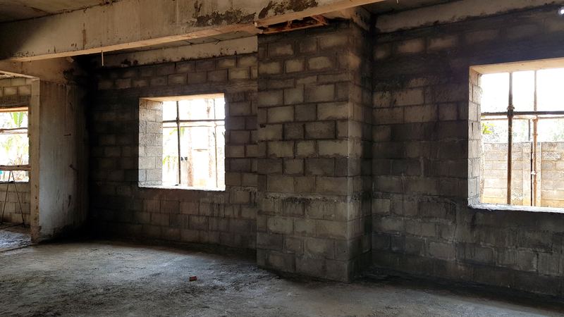 Concrete-block walls and window openings inside the building