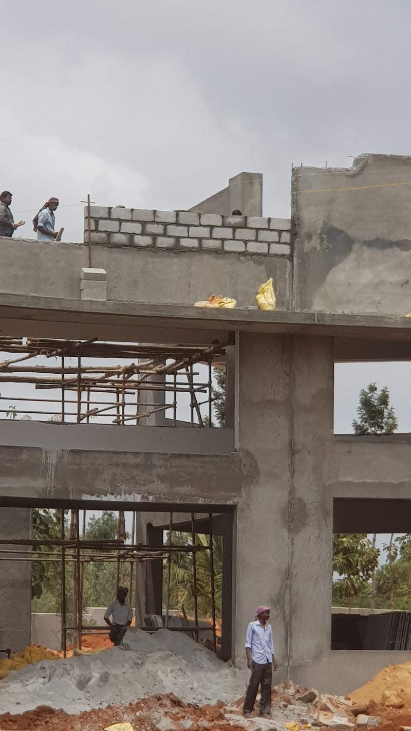 The entrance block in bare concrete and blockwork, before finishing