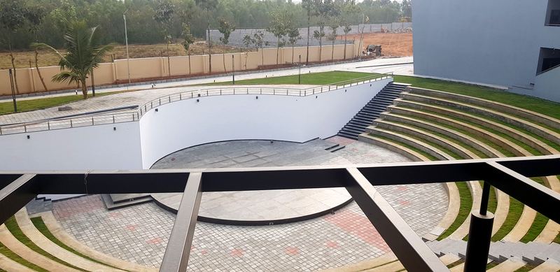 The sunken amphitheatre stage seen through the steel pergola of the upper balcony