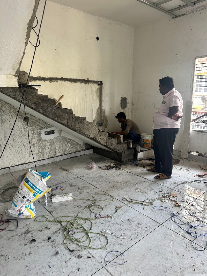 Workers finishing a staircase inside a residential building