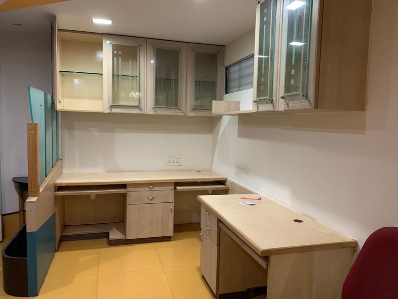 Built-in desks and glass-fronted wall cabinets in an office fit-out