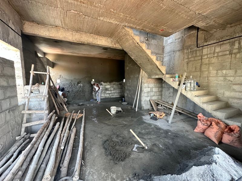 Ground floor inside the building, with the staircase, props and cement bags