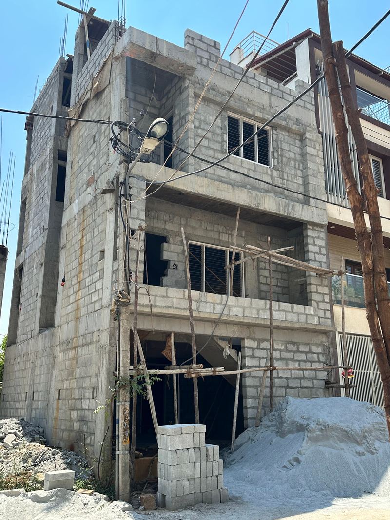 The same building a month later, with windows fitted and scaffolding on the lower floors
