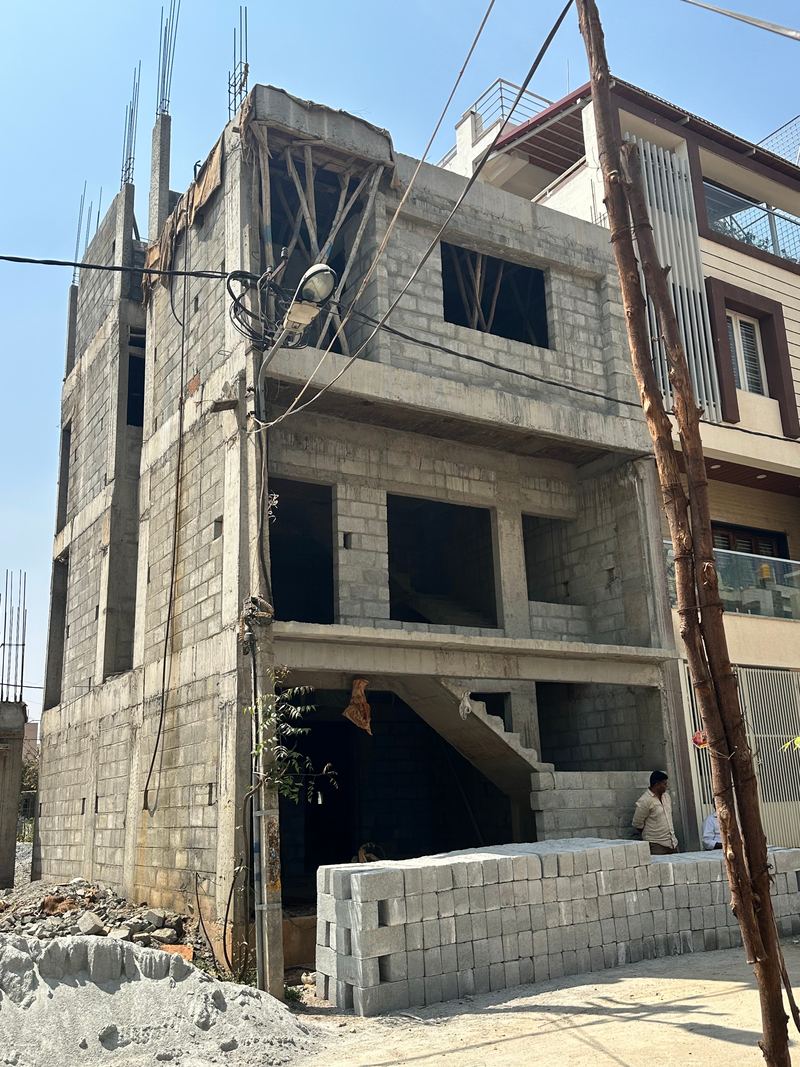 Three-storey residential building with concrete frame and block walls under construction