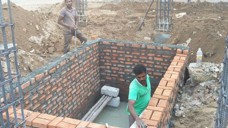 A mason inside a brick-walled chamber below ground