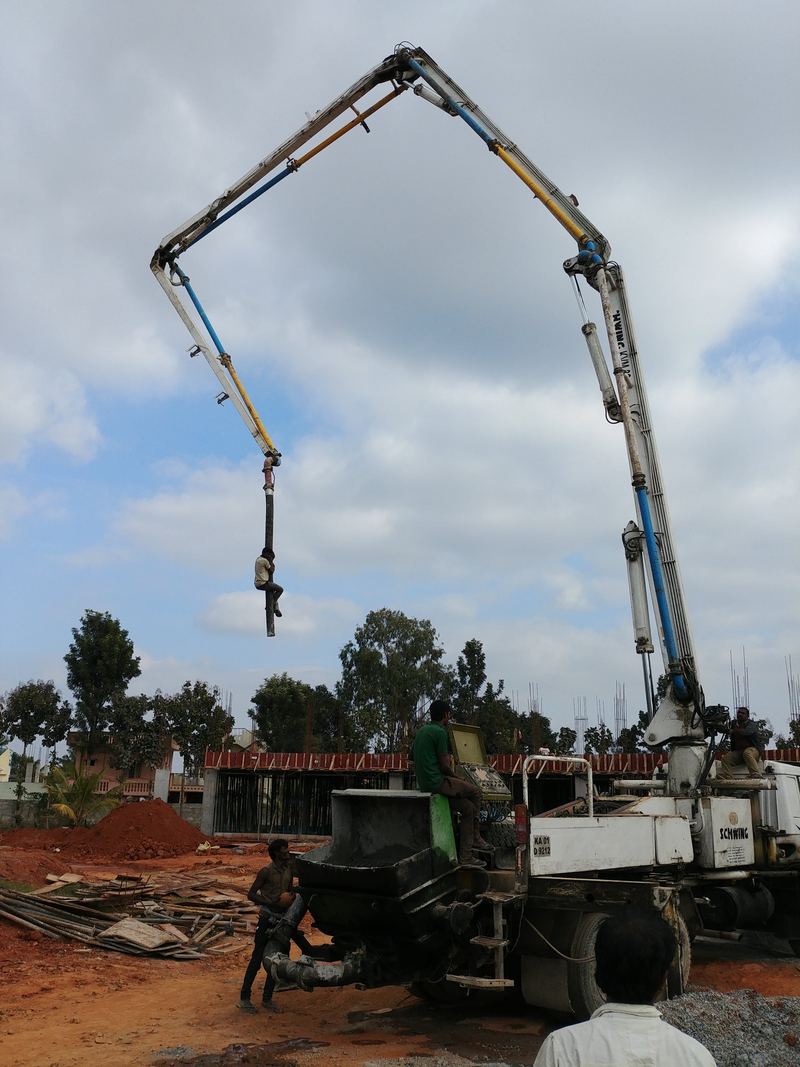 Concrete boom pump placing concrete on a site in Bangalore